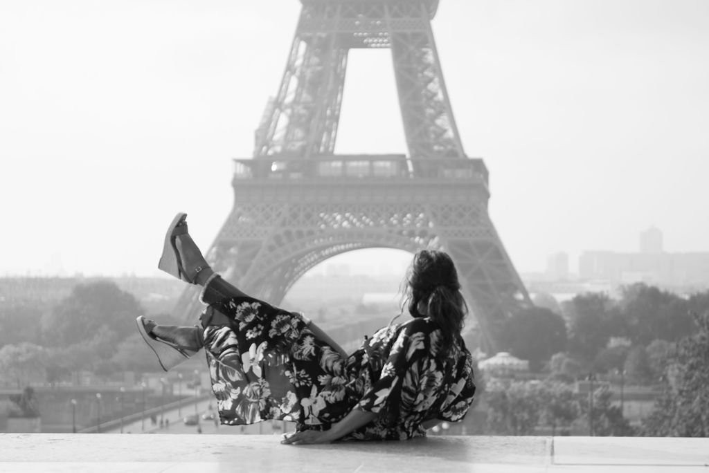 Coach Diesta kicking her feet in front of the Eiffel Tower